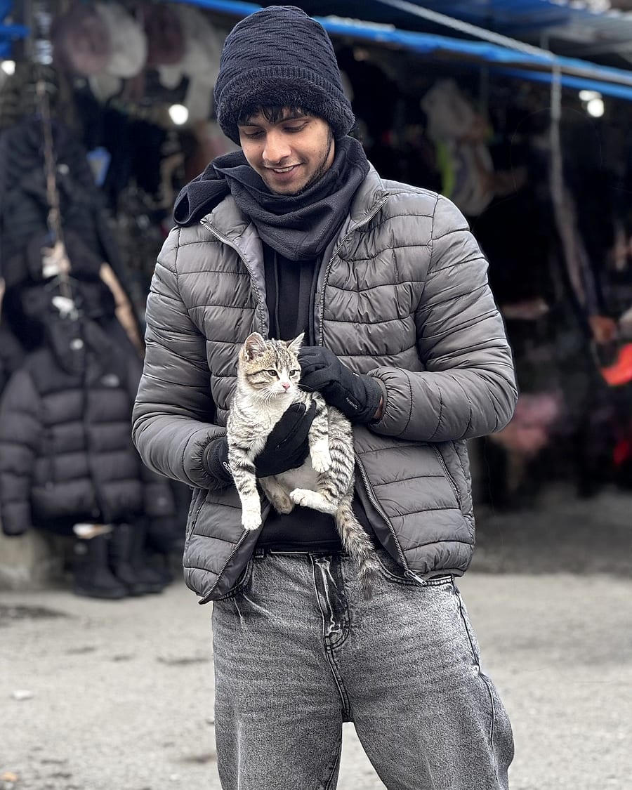 Nasif at a market in Georgia, holding a kitten